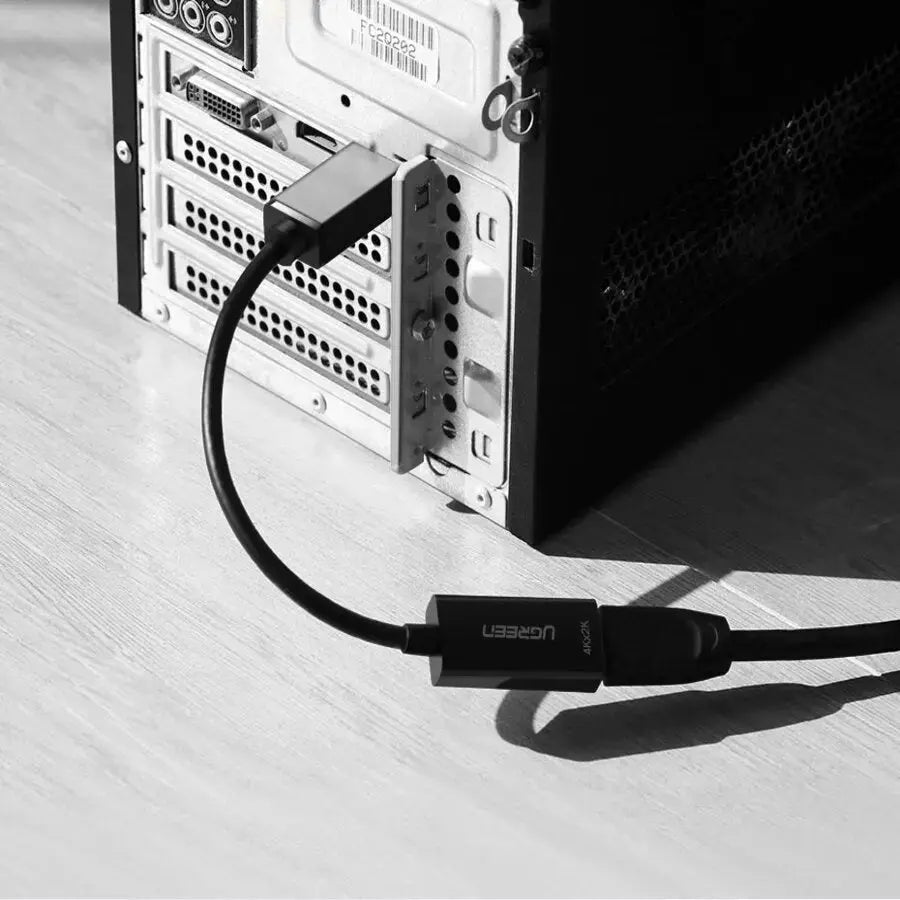 UGREEN DisplayPort to HDMI adapter connected to a desktop graphics card DisplayPort output